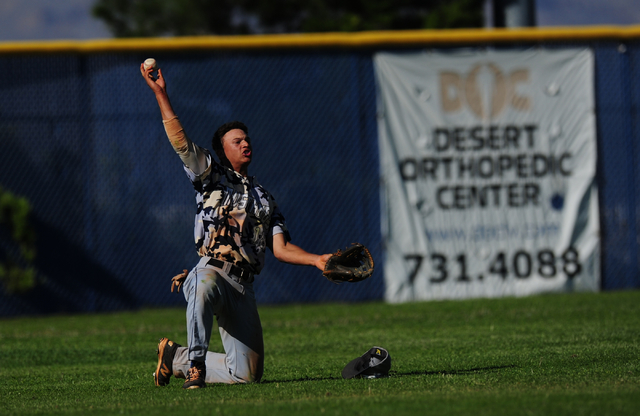 Shadow Ridge left fielder Bryson Barnes shows the ball to the umpire after making a diving c ...