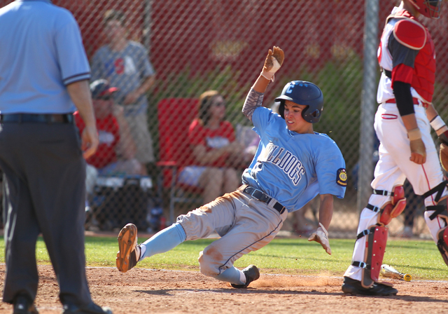 Centennial’s Tanner Wright slides safely into home against Arbor View during the Sunse ...