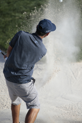 Foothill High School Senior Andrew Chu, hits his ball out of a sand trap during final round ...
