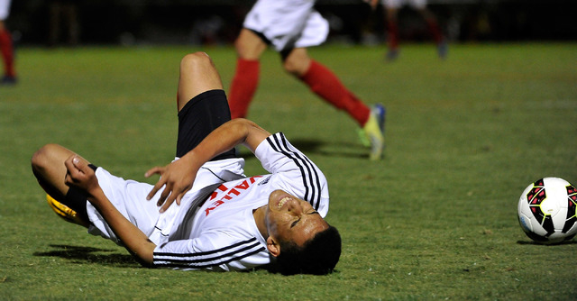 Valley’s’s Damian Alvarez reacts after colliding with an Eldorado player during ...