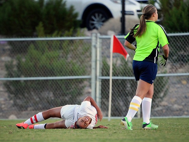 Las Vegas High’s Ashlee Jordan lies on the ground after a collision with Foothill goal ...