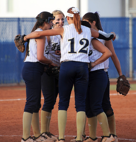 Foothill first baseman Sarah Maddox (12) puts her arms around the rest of the Falcons’ ...