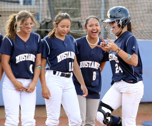 Shadow Ridge senior Justin Garganese, right, prepares to cross home plate after hitting a so ...