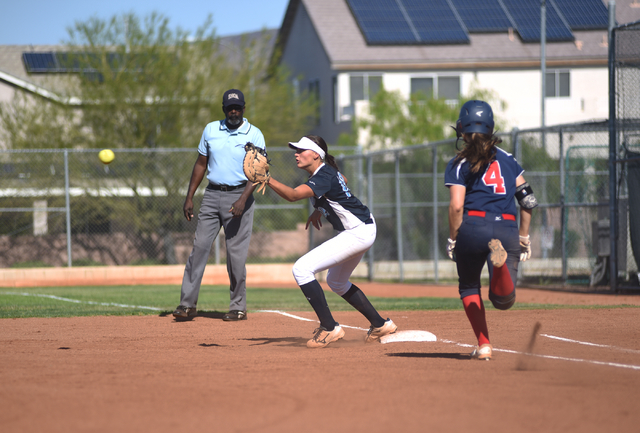 Foothill’s Sarah Maddox (12) takes the throw to put out Coronado’s Dylan Underwo ...