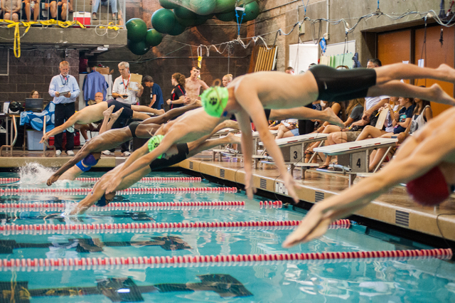 The boys dive in for the start of the 200-yard individual medley race at the Sunset Region m ...