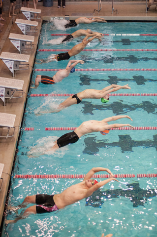 The boys dive in for the start of the 200-yard medley relay race at the Sunset Region meet o ...