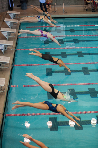 The girls dive in for the start of the 200-yard freestyle race on Saturday at the Sunset Reg ...