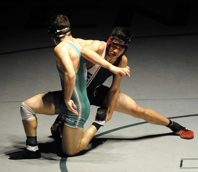 Las Vegas High’s Alii Stewart, left, tries to take down Green Valley’s Jiar Meag ...