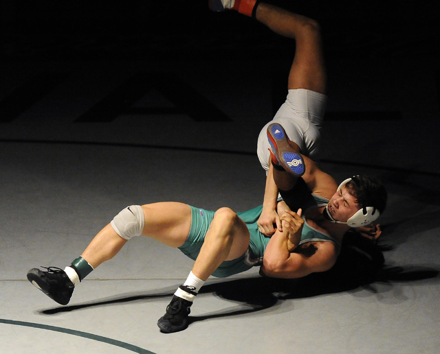 Green Valley’s Sean Cannon wrestles Liberty’s Michael Martinezto the mat during ...