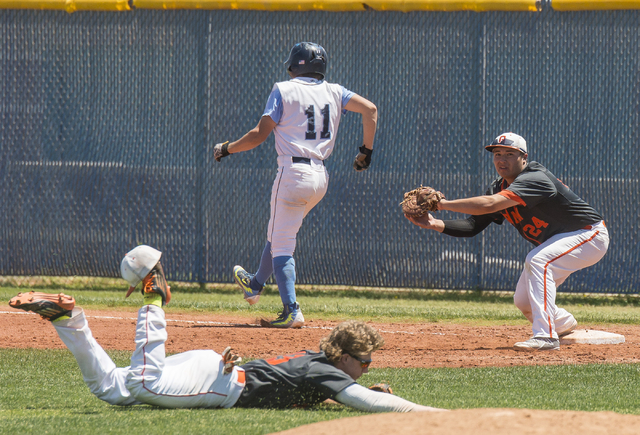 Centennial’s Tanner Wright (11) runs to first base as Bishop Gorman’s Nick Israe ...