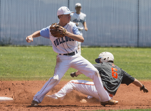 Centennial’s Kian Wilbur (4) completes a double play as Bishop Gorman’s Beau Cap ...