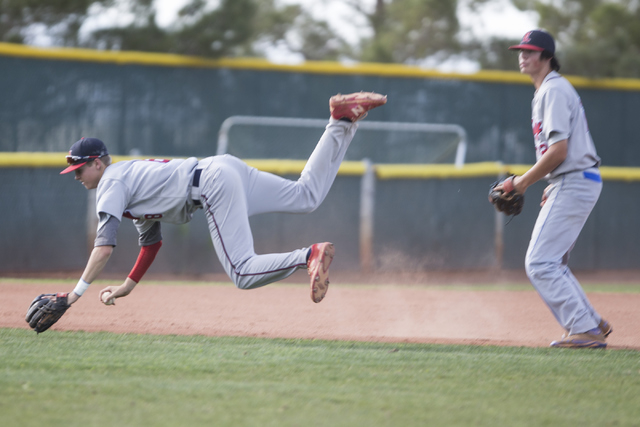 Liberty’s Jacob Rogers (8) falls to the ground after avoiding contact with a teammate ...