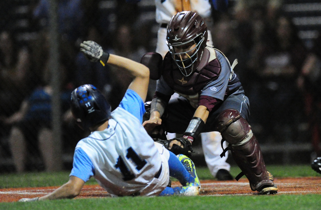 Cimarron-Memorial catcher Cameron Stafford tags out Centennial base runner Tanner Wright in ...
