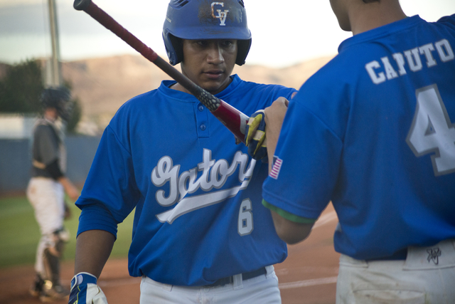 Green Valley’s Jimmy Montiel (6) is congratulated on a run by Justin Caputo (4) during ...