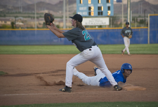 Green Valley’s Drake Maningo (9) slides back to first base as Silverado’s Kevin ...