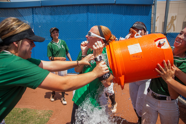 Palo Verde players give their coach Kelly Glass, center, the winning water bath after their ...