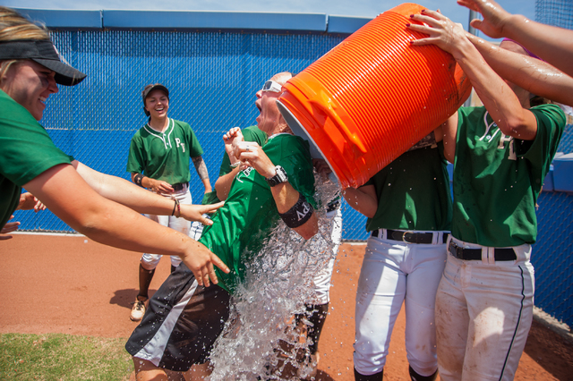 Palo Verde players give their coach Kelly Glass, center, the winning water bath after their ...