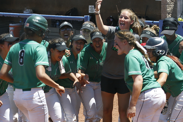 Rancho players gather at home base to congratulate teammate Kayla Coles on her home run agai ...