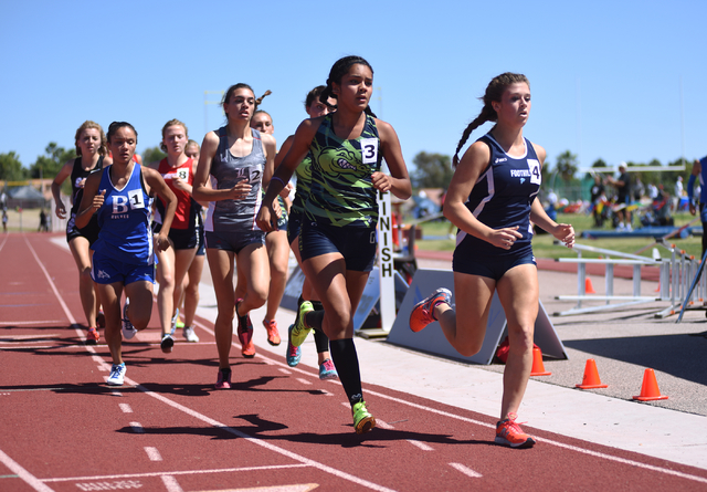 Girls compete in the 800-meter relay at the Sunrise Region meet held at Del Sol High School ...