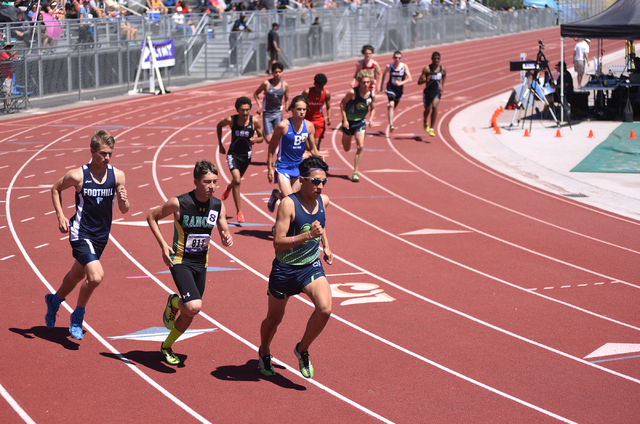 Boys compete in the 1,600-meter run at the Sunrise Region meet held at Del Sol High School i ...