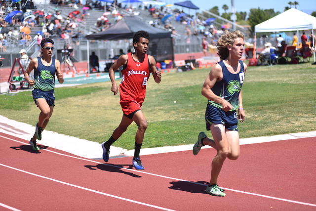 Green Valley’s Austin Rogers, right, leads in the 1,600-meter run at the Sunrise Regio ...