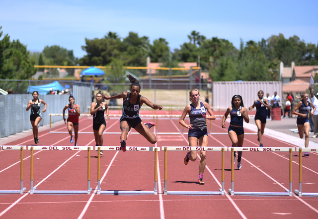 Palo Verde’s Jessica Fields, center, jumps over a hurdle during the 300-meter hurdles ...
