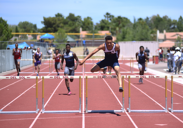 Legacy’s Jamal Britt, center, jumps over a hurdle during the 300-meter hurdles at the ...