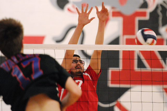 Valley’s Jack Heavey (17) spikes the ball over Las Vegas’ Guillermo Gonzalez (7) ...