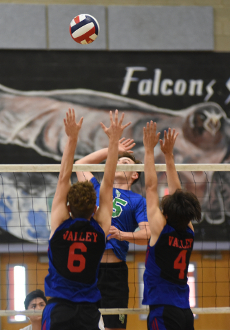 Green Valley’s Dustin Elliott (15) spikes the ball against Valley’s Isaac Frazie ...