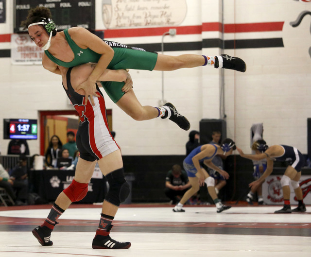 Las Vegas’s Daniel Law, bottom, lifts Rancho’s Joel Serrano during a 132 pounder ...