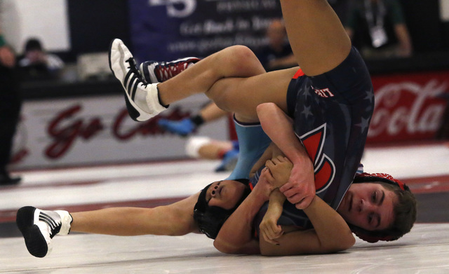Silverado’s Nick Reyes, blue singlet, looks for a pin against Liberty’s Mikaylah ...