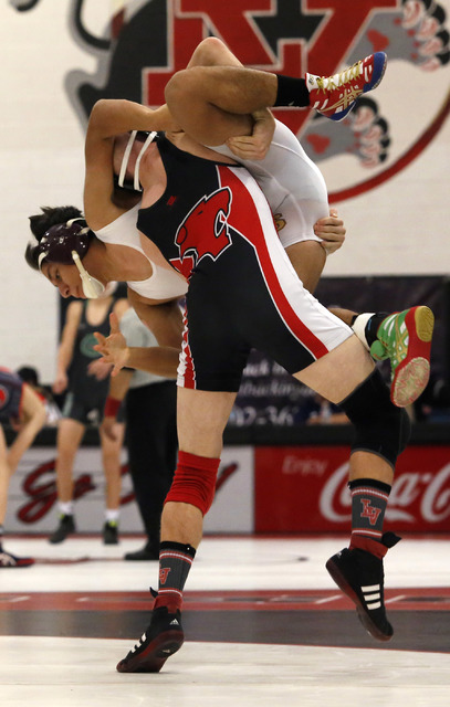 Las Vegas’s Daniel Law, bottom, lifts Eldorado’s Isac Rubio during a 132 pounde ...