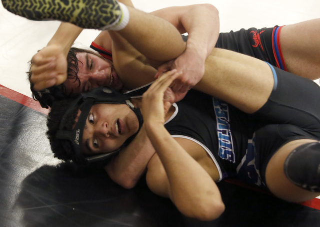 Valley’s Owen Kirtley, top, cradles Silverado’s D’Andre Aitala during a 15 ...