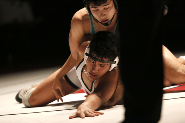 Green Valley’s Giulian Nakamastu, top, wrestles Las Vegas’s Jakob Alvarado durin ...