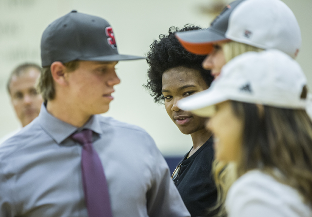 Bishop Gorman’s Skylar Jackson, middle, talks with fellow student athletes expected to ...