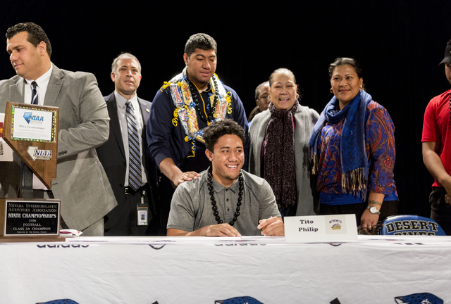 Senior Tito Philip poses after signing to play college football at Western New Mexico Univer ...