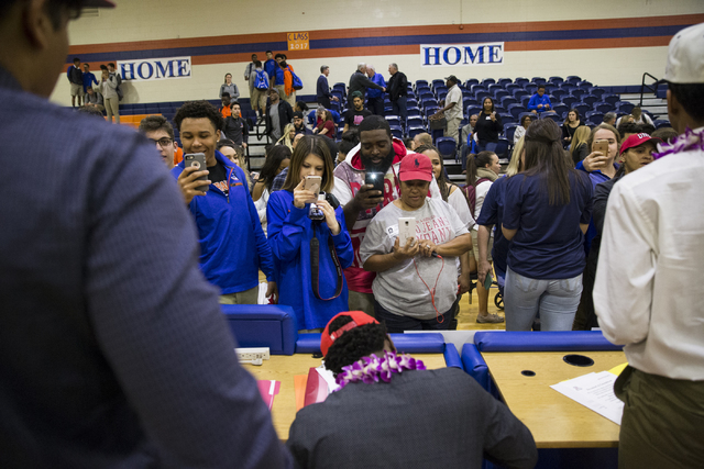 Bishop Gorman football players are photographed by family and friends during Signing Day at ...