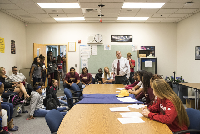 Centennial High School Principal Trent M. Day, center, speaks to the girl’s basketball ...