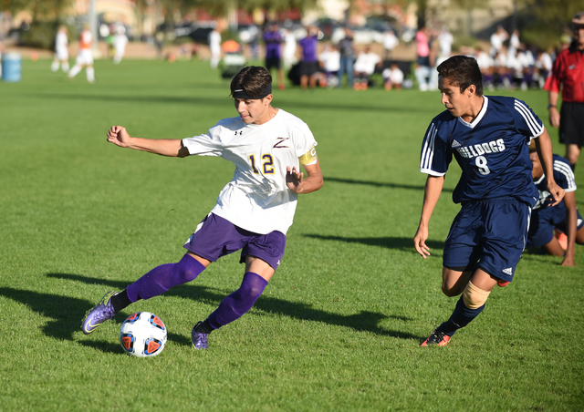 Durango’s Oscar Rodriguez (12) kicks the ball against Centennial’s Jacob Garcia ...
