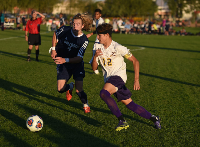Durango’s Oscar Rodriguez (12) kicks the ball against Centennial’s Logan Bodnar ...
