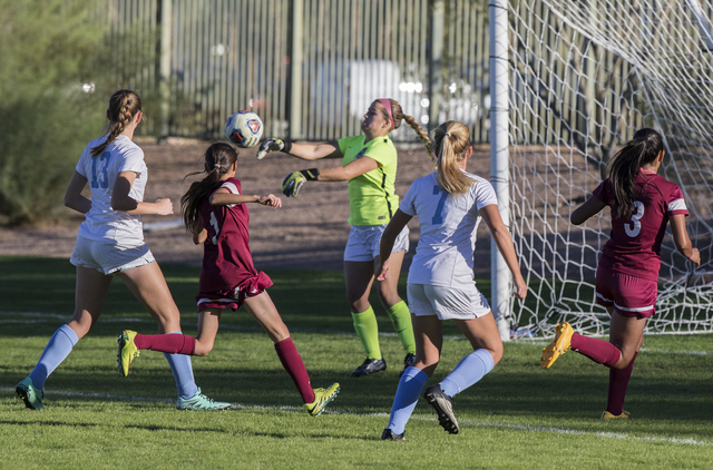 Foothill goalie Natalie Williams (19) punches a ball away during the Sunrise Region girls so ...