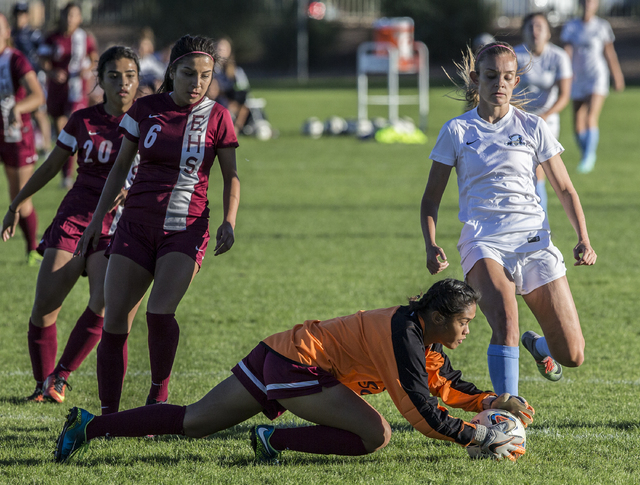 Eldorado goalie Dina Goc’ Ong (8) makes a save in front of Foothill’s Amber Rish ...