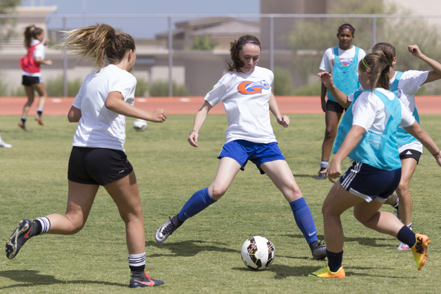 Hannah Borgel (24), center, kicks the ball during girls soccer practice at Bishop Gorman Hig ...