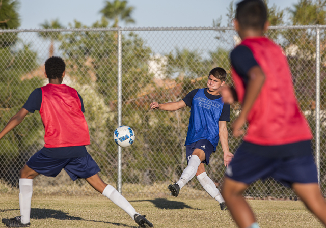 Spring Valley soccer player David Van Hoose, center, makes a pass during practice on Wednesd ...