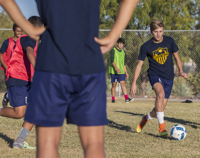 Spring Valley soccer player Ethan Orme (11) dribbles past defenders during practice on Wedne ...