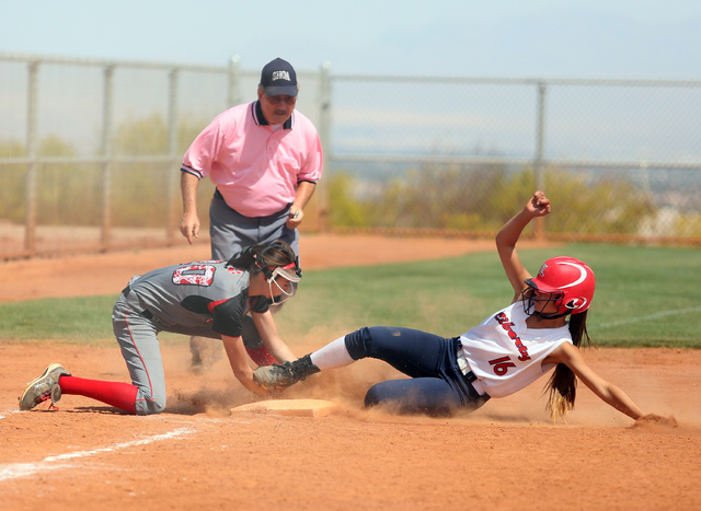 Lincoln County’s Easton Tingey, left, tags out Liberty’s Ashleigh Rodriguez at t ...