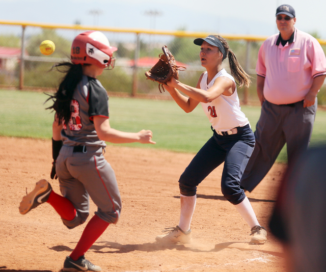 Lincoln County’s Alisha Rowe, left, runs to first base as Liberty’s Kylie Hefley ...