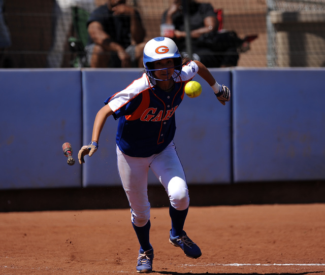 Bishop Gorman player Monique Passalacqua bunts her way to first base against Rancho in the f ...