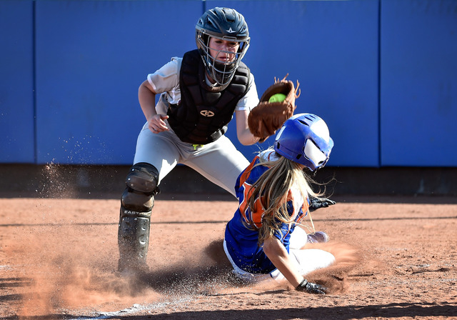 Bishop Gorman’s Ashley Witucki beats the tag by Faith Lutheran catcher Claire Peck as ...