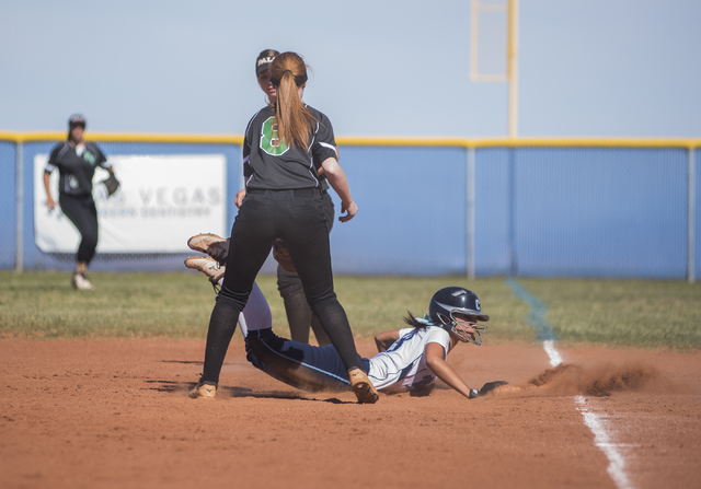 Centennial High School’s Angel Love (8) is safe at first base as she attempts to not g ...